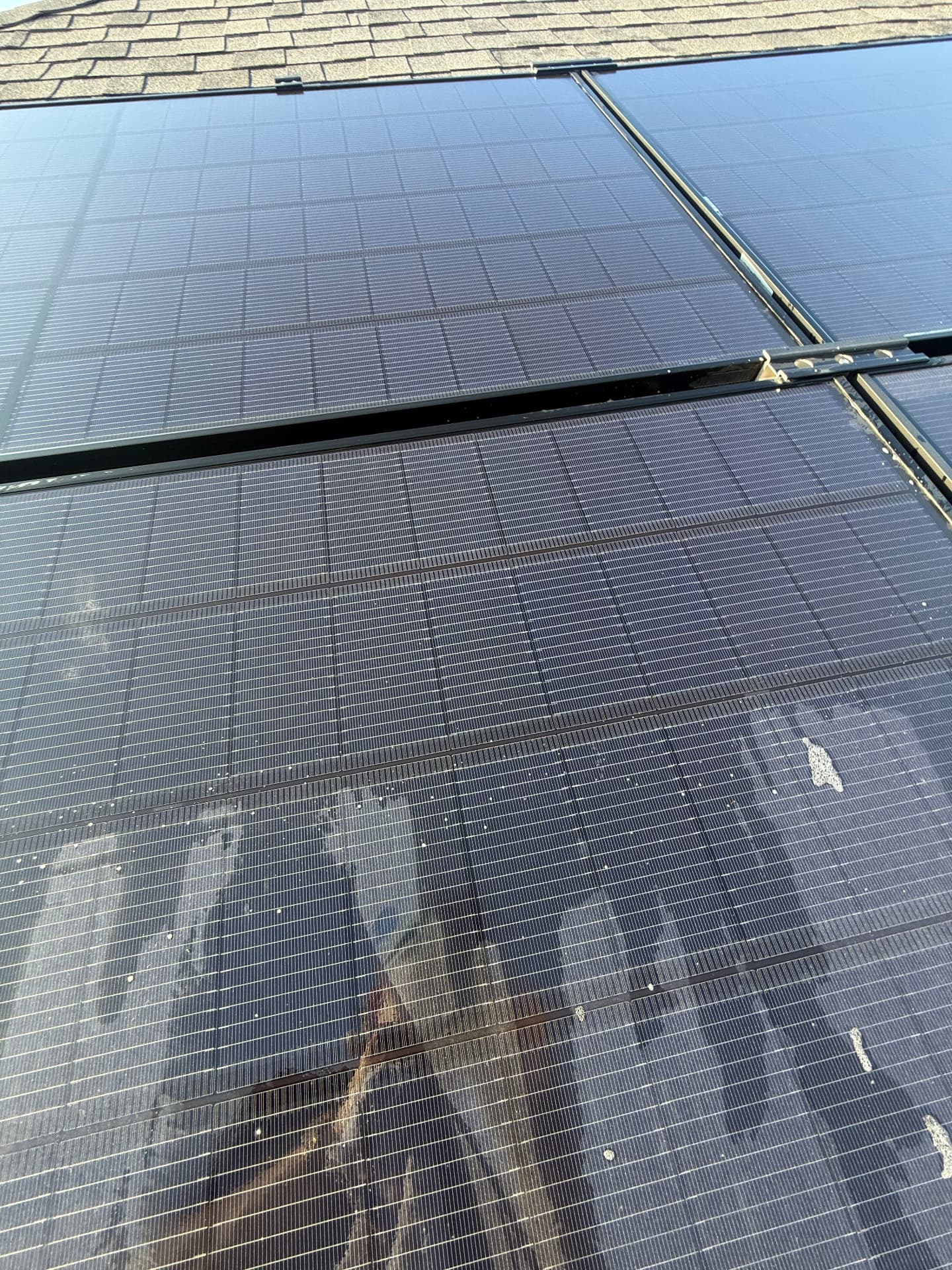 San Marcos solar panels with hard water spotting and dust film before service